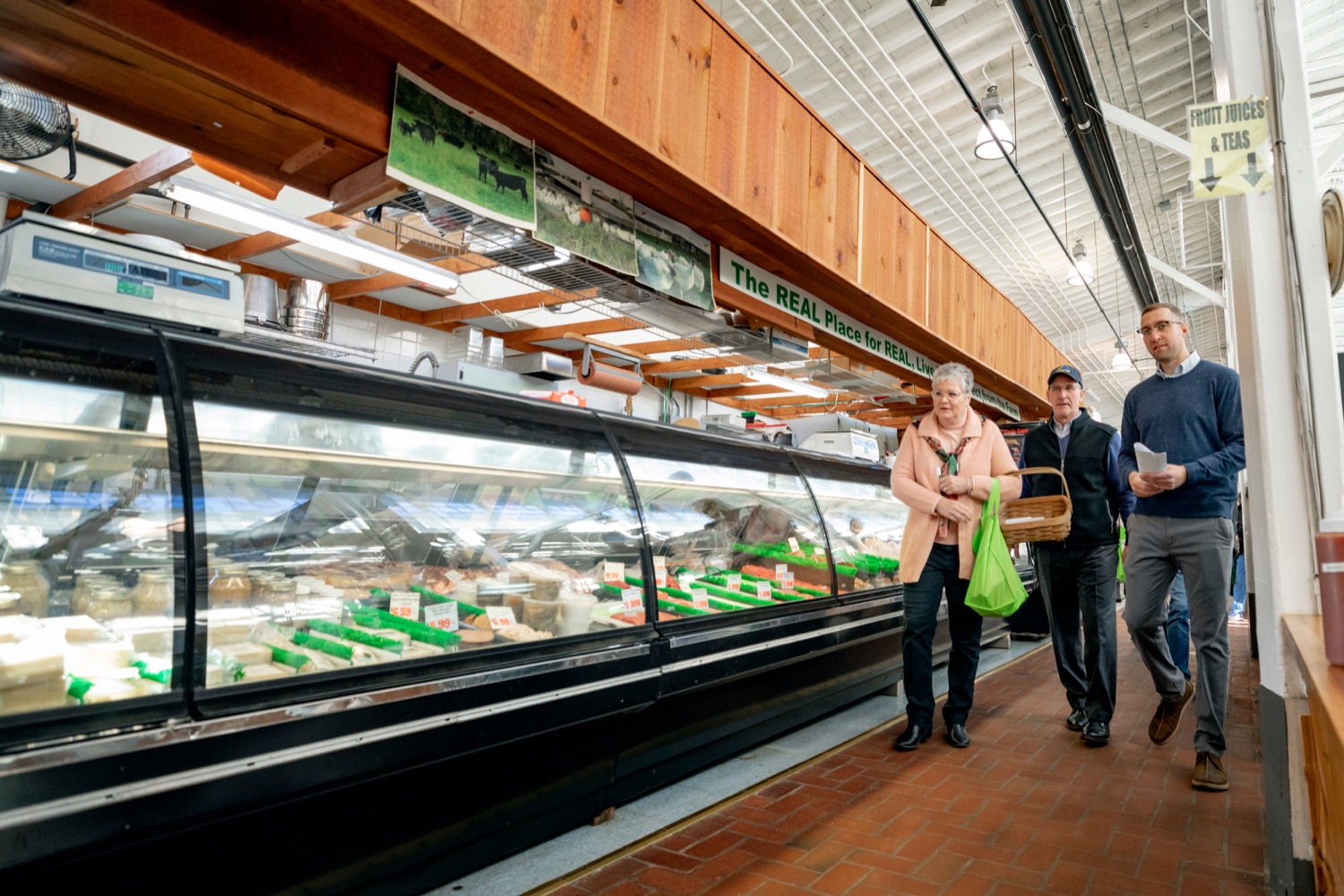 Josh Heilman, executive director of Broad Street Alliance, right, walks with Pennsylvania Department of Agriculture Secretary Russell Redding, center, and Nina Redding, inside Broad Street Market on Thursday, November 21, 2019.<br><a href="https://filesource.amperwave.net/commonwealthofpa/photo/17546_AGRIC_Buy_Local_NK_016.JPG" target="_blank">⇣ Download Photo</a>