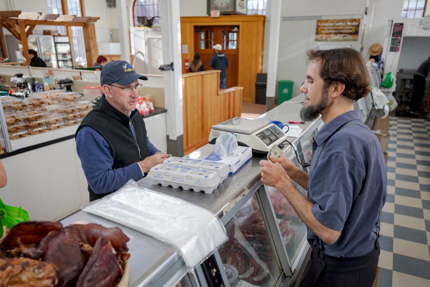 Steve Stoltzfus, owner of Lebanon Valley Meats, grabs two dozen eggs for Pennsylvania Department of Agriculture Secretary Russell Redding inside Broad Street Market on Thursday, November 21, 2019.<br><a href="https://filesource.amperwave.net/commonwealthofpa/photo/17546_AGRIC_Buy_Local_NK_023.JPG" target="_blank">⇣ Download Photo</a>