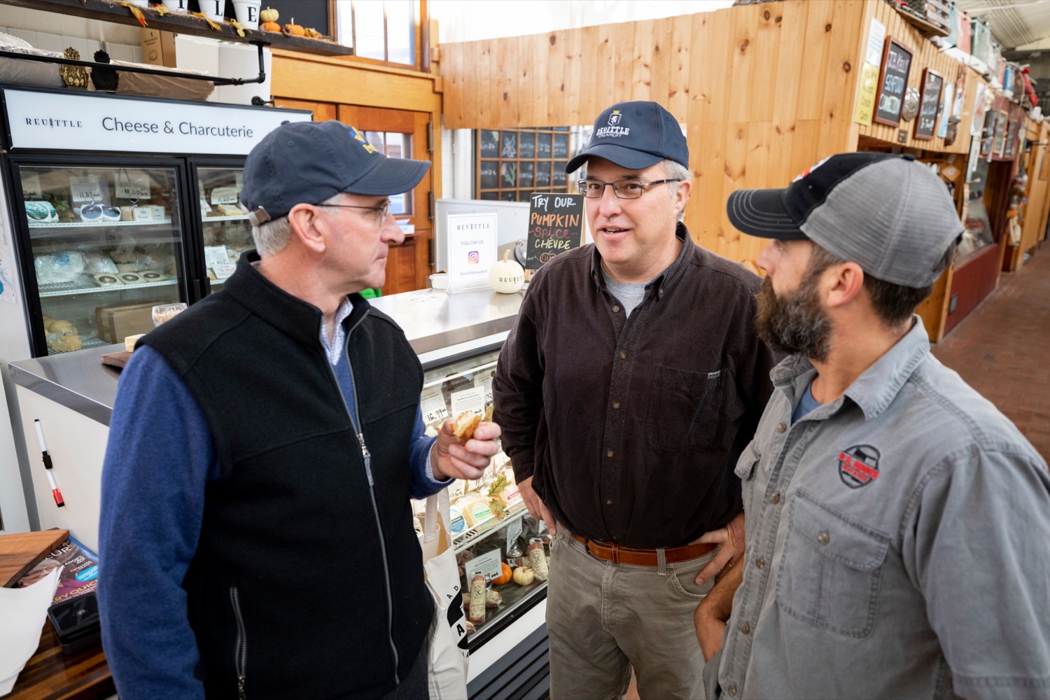 Pennsylvania Department of Agriculture Secretary Russell Redding talks with Mark Zimmerman, owner of Revittle Market, center, and Ryan Hummer, owner of R.G. Hummer Meat & Cheese, right, while grocery shopping for Thanksgiving dinner inside Broad Street Market on Thursday, November 21, 2019.<br><a href="https://filesource.amperwave.net/commonwealthofpa/photo/17546_AGRIC_Buy_Local_NK_024.JPG" target="_blank">⇣ Download Photo</a>