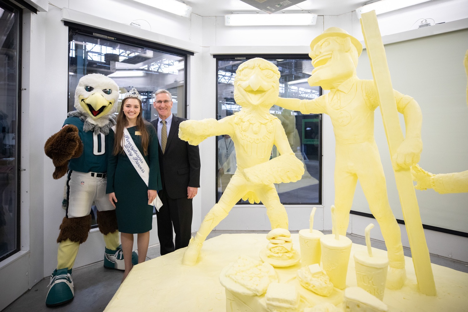 Lt. Governor John Fetterman and Secretary of Agriculture Russell Redding today unveiled the 2020 Pennsylvania Farm Show butter sculpture, carved from a half-ton of butter depicting three of Pennsylvanias beloved professional sports mascots: Philadelphia Flyers Gritty, Philadelphia Eagles Swoop, and Pittsburgh Steelers Steely McBeam celebrating with a spread of Pennsylvania dairy products. The sculpture, a long-time Farm Show staple, encourages Pennsylvanians to be a fan of Pennsylvania dairy and give a cheer to the more than 6,200 dairy farmers in the commonwealth.  Harrisburg, PA  January 2, 2020<br><a href="https://filesource.amperwave.net/commonwealthofpa/photo/17646_agric_butter_sculpture_dz_012.jpg" target="_blank">⇣ Download Photo</a>