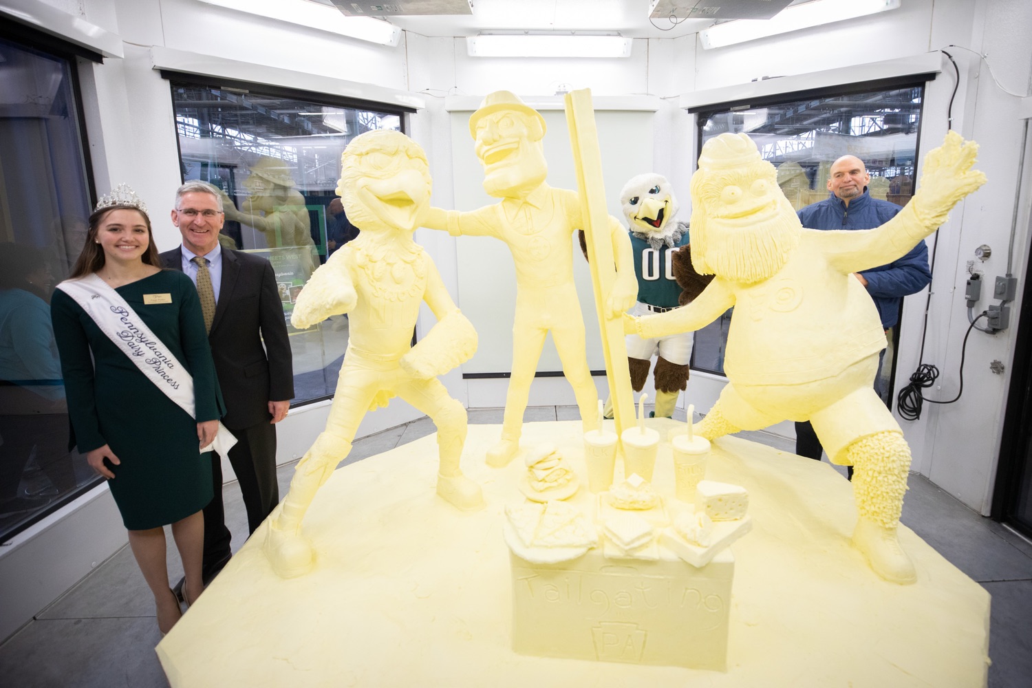 Lt. Governor John Fetterman and Secretary of Agriculture Russell Redding today unveiled the 2020 Pennsylvania Farm Show butter sculpture, carved from a half-ton of butter depicting three of Pennsylvanias beloved professional sports mascots: Philadelphia Flyers Gritty, Philadelphia Eagles Swoop, and Pittsburgh Steelers Steely McBeam celebrating with a spread of Pennsylvania dairy products. The sculpture, a long-time Farm Show staple, encourages Pennsylvanians to be a fan of Pennsylvania dairy and give a cheer to the more than 6,200 dairy farmers in the commonwealth.  Harrisburg, PA  January 2, 2020<br><a href="https://filesource.amperwave.net/commonwealthofpa/photo/17646_agric_butter_sculpture_dz_020.jpg" target="_blank">⇣ Download Photo</a>