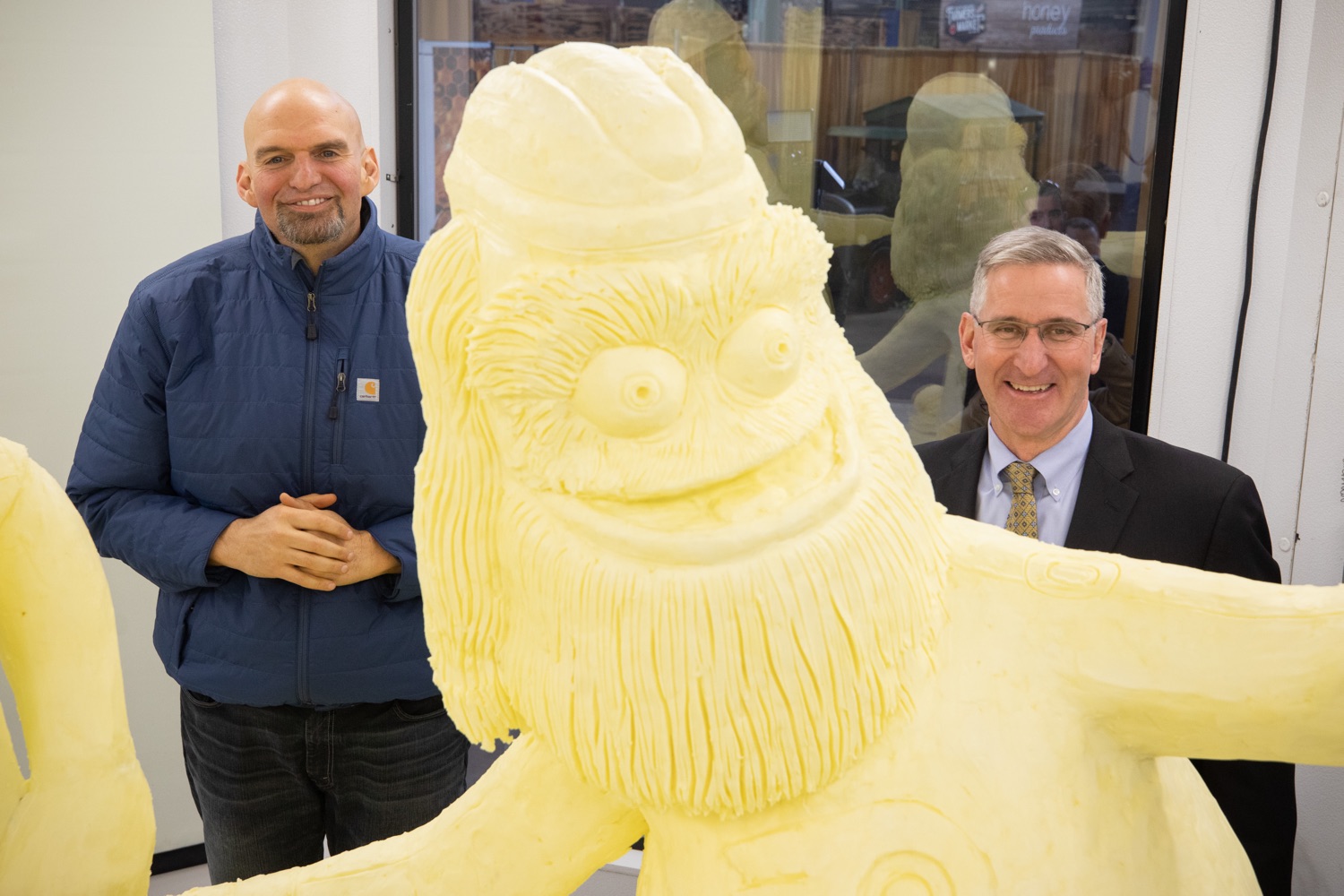 Lt. Governor John Fetterman,  and Secretary of Agriculture Russell Redding at the Pennsylvania Farm Show butter sculpture.  Lt. Governor John Fetterman and Secretary of Agriculture Russell Redding today unveiled the 2020 Pennsylvania Farm Show butter sculpture, carved from a half-ton of butter depicting three of Pennsylvanias beloved professional sports mascots: Philadelphia Flyers Gritty, Philadelphia Eagles Swoop, and Pittsburgh Steelers Steely McBeam celebrating with a spread of Pennsylvania dairy products. The sculpture, a long-time Farm Show staple, encourages Pennsylvanians to be a fan of Pennsylvania dairy and give a cheer to the more than 6,200 dairy farmers in the commonwealth.  Harrisburg, PA  January 2, 2020<br><a href="https://filesource.amperwave.net/commonwealthofpa/photo/17646_agric_butter_sculpture_dz_023.jpg" target="_blank">⇣ Download Photo</a>