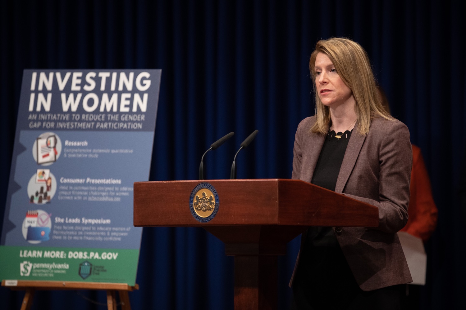 Julie Bancroft, Chief Public Affairs Officer of the Pennsylvania Coalition Against Domestic Violence (PCADV) speaking at the announcement in the Capitol Media Center. Pennsylvania Department of Banking and Securities Secretary Robin L. Wiessmann today announced Investing in Women, an initiative aimed at providing women with important information about banking, credit, saving and investing, while offering practical resources to navigate their finances. The secretary was joined at a Capitol news conference by .Julie Bancroft, Chief Public Affairs Officer of the Pennsylvania Coalition Against Domestic Violence (PCADV).  .Harrisburg, PA - January 15, 2020.<br><a href="https://filesource.amperwave.net/commonwealthofpa/photo/17725_dobs_investingwomen_dz_009.jpg" target="_blank">⇣ Download Photo</a>