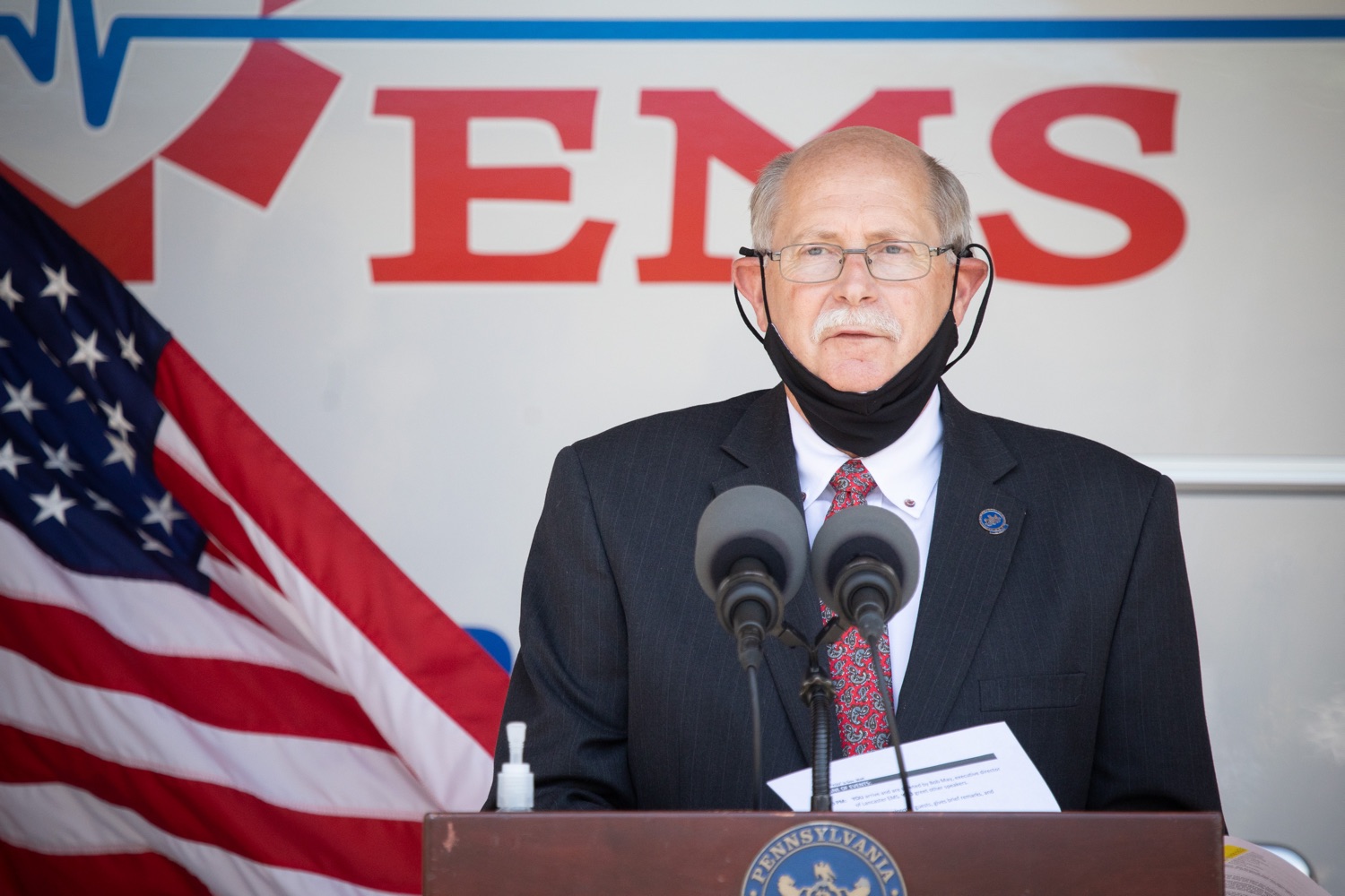 Pennsylvania State Fire Commissioner, Bruce Trego speaking to the press. Governor Tom Wolf visited the Millersville location of Lancaster EMS today to thank first responders and learn about how they are adapting their critical work during the states response to the COVID-19 pandemic.  Millersville, PA  July 30, 2020<br><a href="https://filesource.amperwave.net/commonwealthofpa/photo/18180_gov_first_responders_dz_007.jpg" target="_blank">⇣ Download Photo</a>