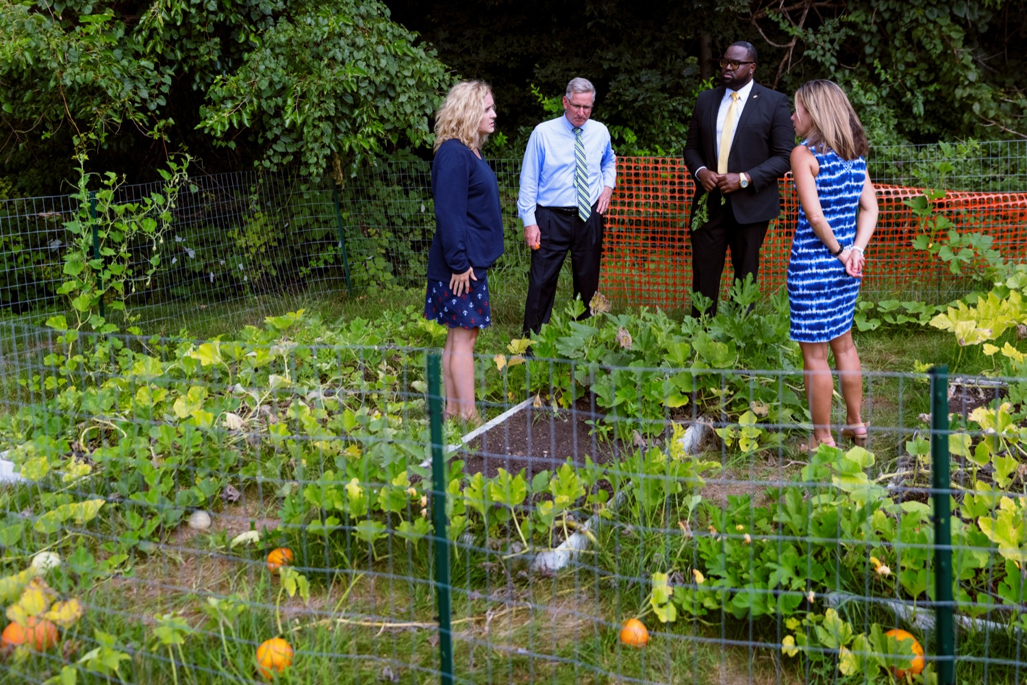 From left; Meredith Seidel, teacher at Hill Top Academy; PA Dept. of Agriculture Secretary Russell Redding; Stephon Fitzpatrick, executive director of Pennsylvania commission for Agriculture Education Excellence, and Vonda Ramp, PA Dept. of Education director of Childhood Nutrition Programs, take a tour of a garden during a press conference, which highlighted the success of Pennsylvania's farm to school programs, at Hill Top Academy in Mechanicsburg on Friday, August 27, 2021.<br><a href="https://filesource.amperwave.net/commonwealthofpa/photo/19054_AGRIC_FarmToSchool_NK_003.jpg" target="_blank">⇣ Download Photo</a>