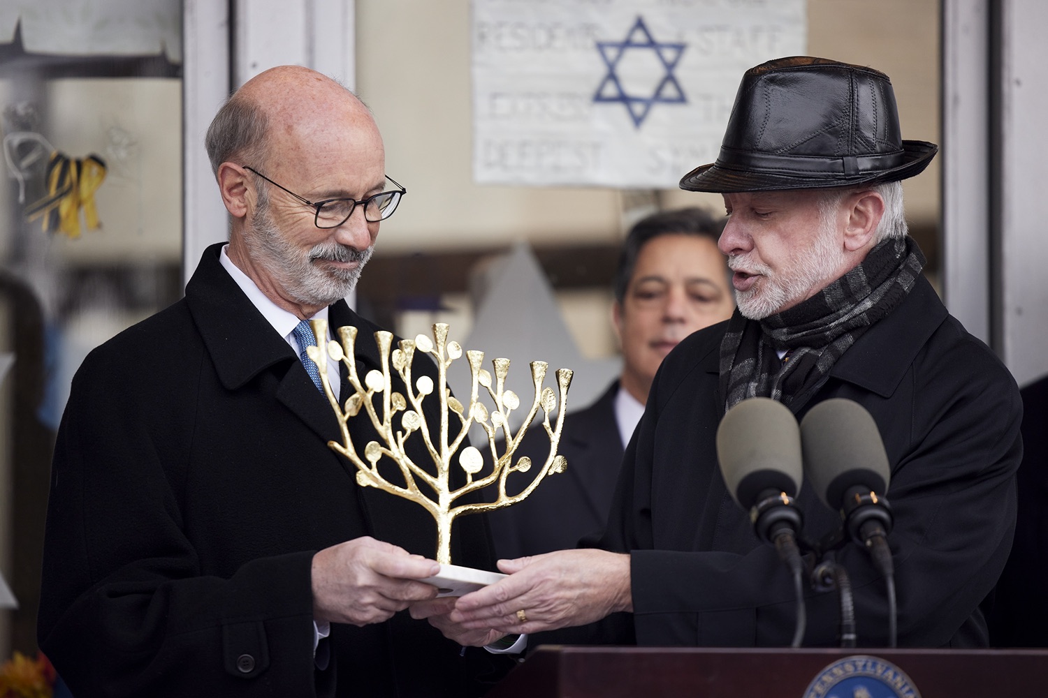 Rabbi Jeffrey Myers presenting a gift to the people of Pennsylvania, a Tree of Life Menorah.  Governor Tom Wolf visited the Tree of Life in Pittsburgh today to announce $6.6 million in state funding to support the rebuilding and reimagining of the synagogue. The governor was joined by Rabbi Jeffrey Myers, Senate Democratic Leader Jay Costa and members of the Tree of Lifes REMEMBER. REBUILD. RENEW campaign which will transform the site of the worst antisemitic attack in U.S. history into a new place of hope, remembrance, and education. Pittsburgh, PA - December 6, 2021<br><a href="https://filesource.amperwave.net/commonwealthofpa/photo/20308_gov_treeOfLife_dz_001_copy.jpg" target="_blank">⇣ Download Photo</a>