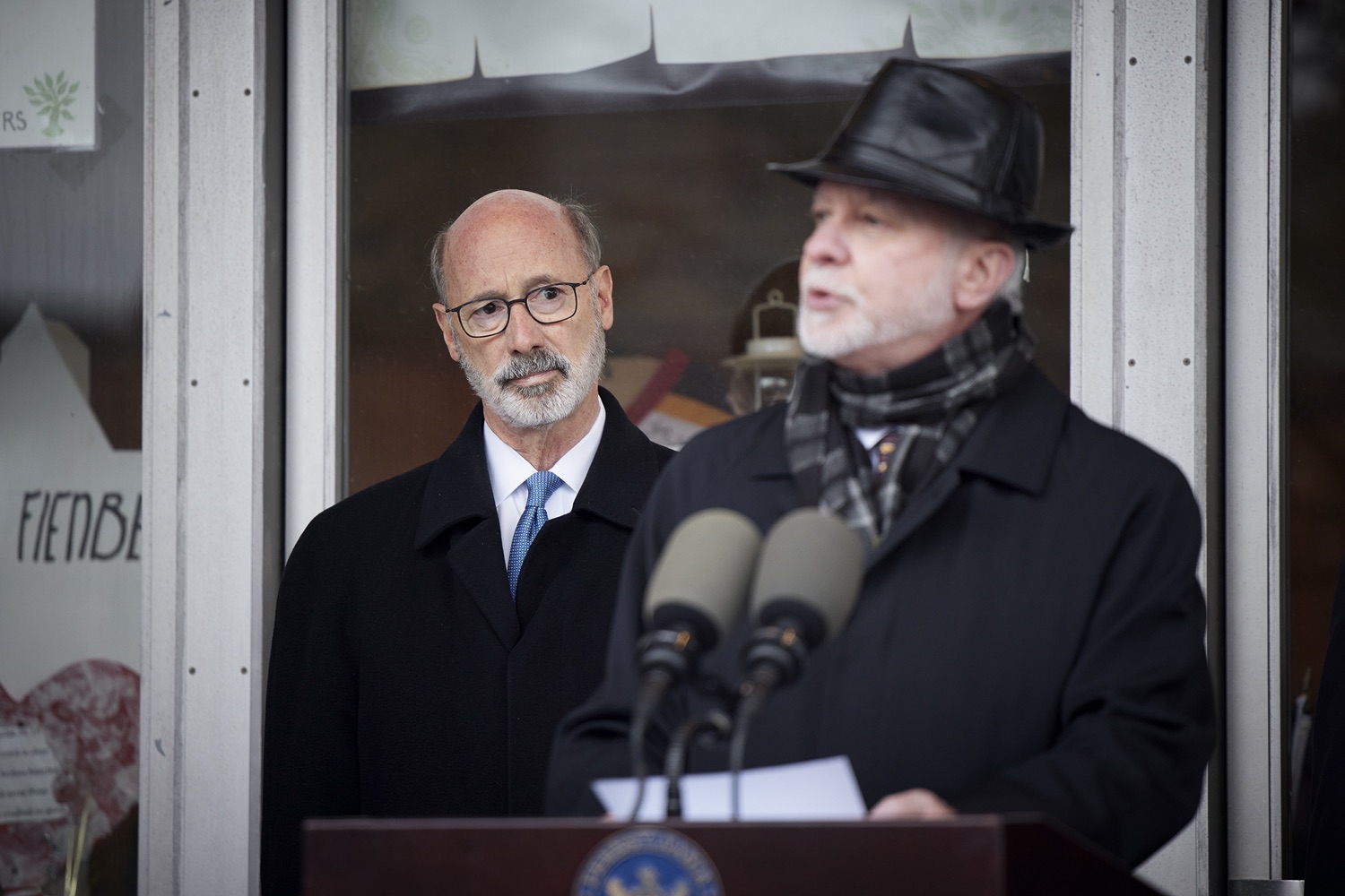 Pennsylvania Governor Tom Wolf listens as Rabbi Jeffrey Myers speaks with the press.  Governor Tom Wolf visited the Tree of Life in Pittsburgh today to announce $6.6 million in state funding to support the rebuilding and reimagining of the synagogue. The governor was joined by Rabbi Jeffrey Myers, Senate Democratic Leader Jay Costa and members of the Tree of Lifes REMEMBER. REBUILD. RENEW campaign which will transform the site of the worst antisemitic attack in U.S. history into a new place of hope, remembrance, and education. Pittsburgh, PA - December 6, 2021<br><a href="https://filesource.amperwave.net/commonwealthofpa/photo/20308_gov_treeOfLife_dz_009_copy.jpg" target="_blank">⇣ Download Photo</a>