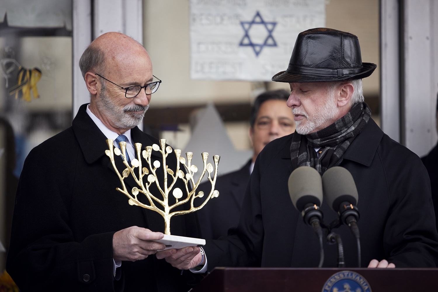 Rabbi Jeffrey Myers presenting a gift to the people of Pennsylvania, a Tree of Life Menorah.  Governor Tom Wolf visited the Tree of Life in Pittsburgh today to announce $6.6 million in state funding to support the rebuilding and reimagining of the synagogue. The governor was joined by Rabbi Jeffrey Myers, Senate Democratic Leader Jay Costa and members of the Tree of Lifes REMEMBER. REBUILD. RENEW campaign which will transform the site of the worst antisemitic attack in U.S. history into a new place of hope, remembrance, and education. Pittsburgh, PA - December 6, 2021<br><a href="https://filesource.amperwave.net/commonwealthofpa/photo/20308_gov_treeOfLife_dz_011_copy.jpg" target="_blank">⇣ Download Photo</a>
