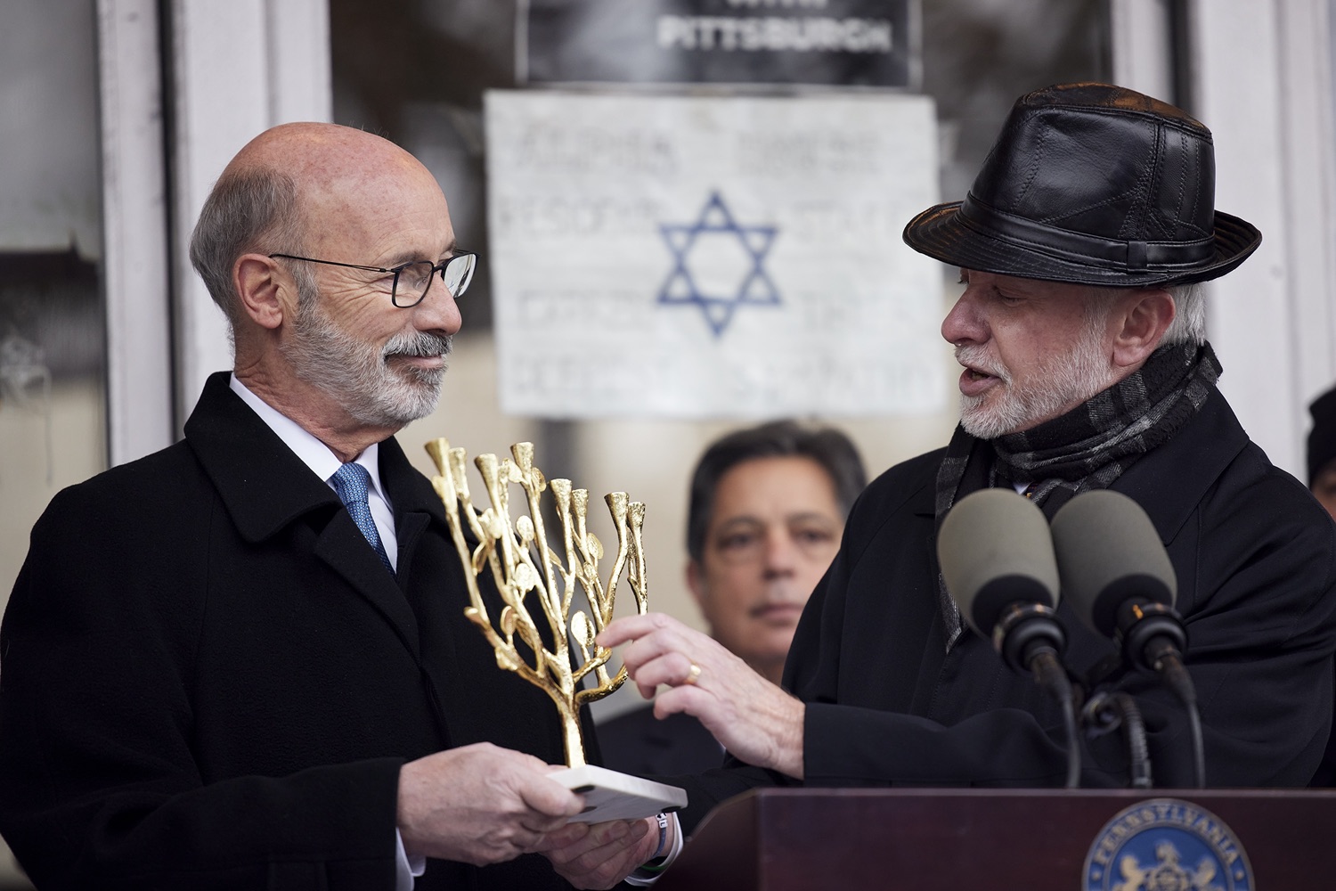 Rabbi Jeffrey Myers presenting a gift to the people of Pennsylvania, a Tree of Life Menorah.  Governor Tom Wolf visited the Tree of Life in Pittsburgh today to announce $6.6 million in state funding to support the rebuilding and reimagining of the synagogue. The governor was joined by Rabbi Jeffrey Myers, Senate Democratic Leader Jay Costa and members of the Tree of Lifes REMEMBER. REBUILD. RENEW campaign which will transform the site of the worst antisemitic attack in U.S. history into a new place of hope, remembrance, and education. Pittsburgh, PA - December 6, 2021<br><a href="https://filesource.amperwave.net/commonwealthofpa/photo/20308_gov_treeOfLife_dz_021_copy.jpg" target="_blank">⇣ Download Photo</a>