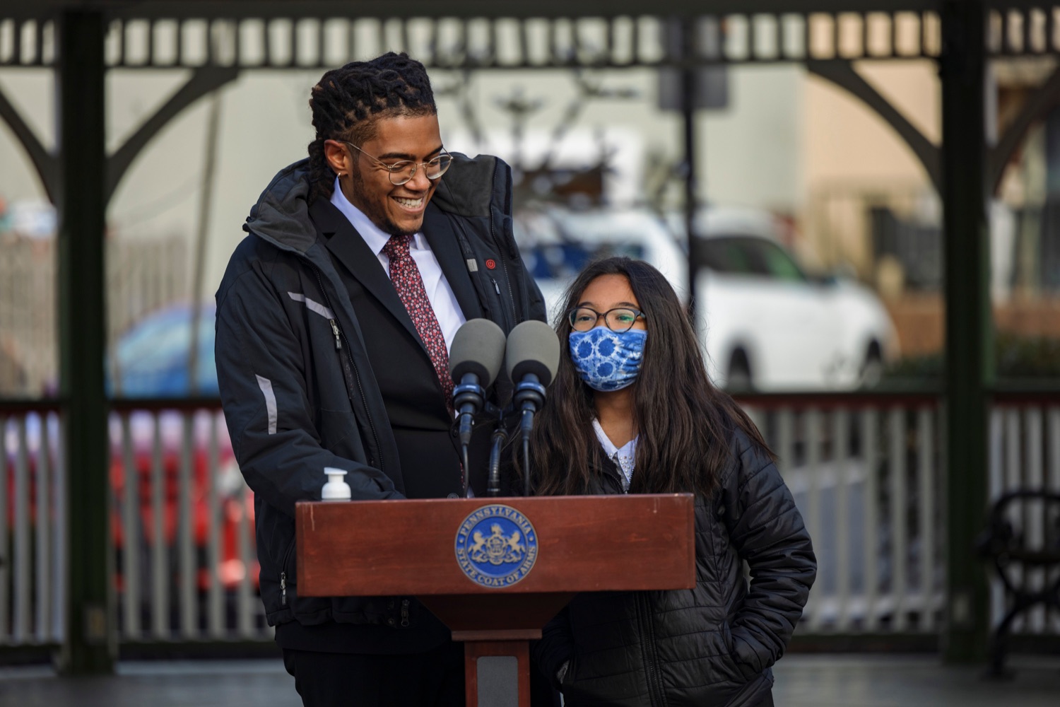 Victor Cabral, Office of Advocacy and Reform deputy director, with his 9-year-old daughter, Bella, during an event observing the "Day of Racial Healing" in Pennsylvania at Jenkintown Town Square on Tuesday, January 18, 2022. By proclamation of Governor Tom Wolf, Pennsylvania joined communities across the United States in mobilizing events and activities that support bringing racial healing into homes, communities, and institutions. This is a call to action to work together and heal the wounds of racial bias and commit to building an equitable and just society so that all residents can thrive.<br><a href="https://filesource.amperwave.net/commonwealthofpa/photo/20315_OAR_RacialHealing_NK_023.JPG" target="_blank">⇣ Download Photo</a>