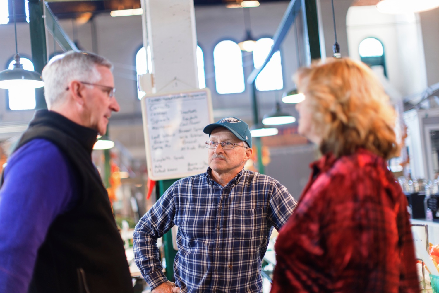 Agriculture Secretary Russell Redding, left, talks with Dennis Fritz and his wife, Barb, inside York Central Market House on Thursday, November 17, 2022.<br><a href="https://filesource.amperwave.net/commonwealthofpa/photo/22347_AG_Thanksgiving_Shopping_NK_010.JPG" target="_blank">⇣ Download Photo</a>