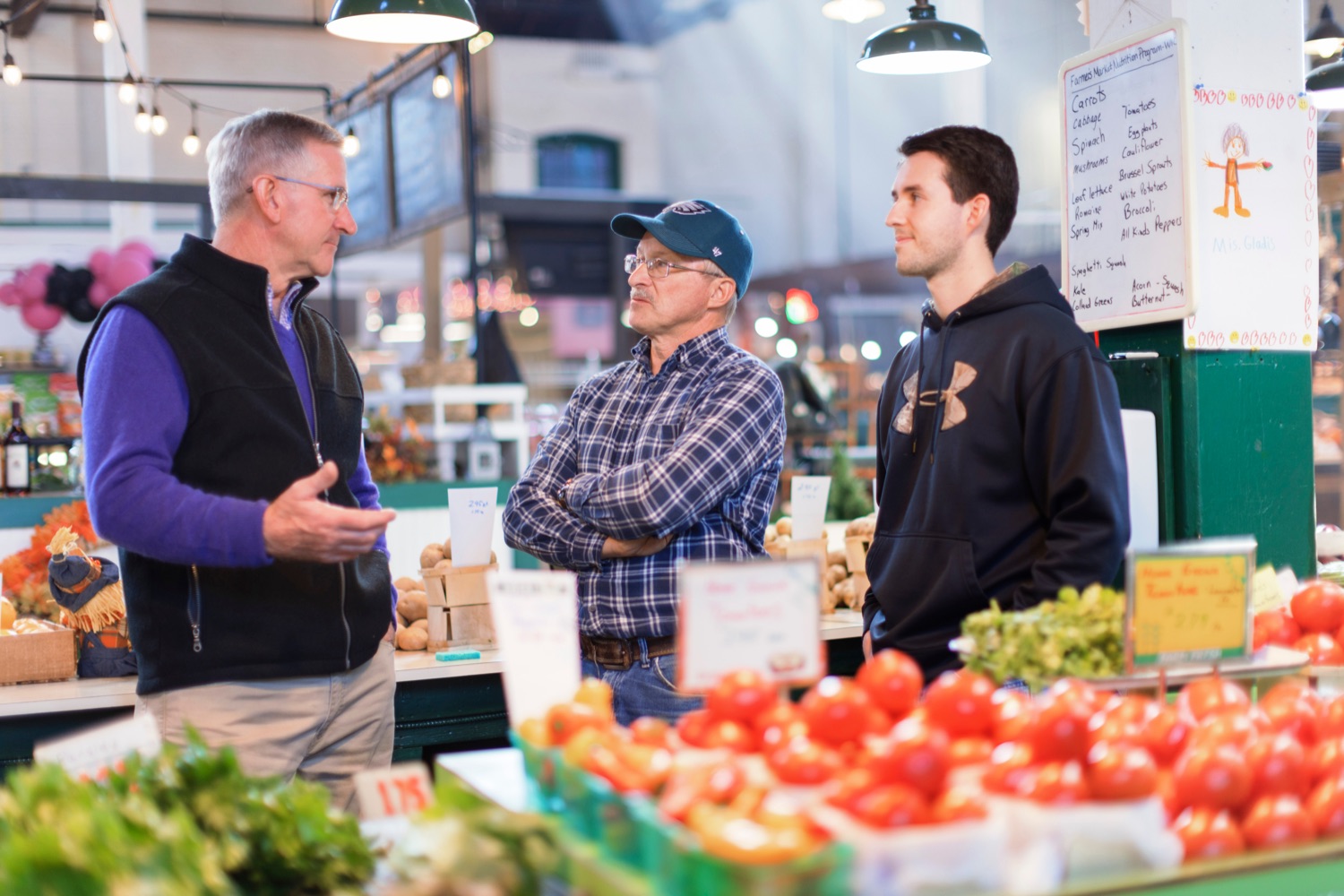 Agriculture Secretary Russell Redding, left, talks with Dennis Fritz and his son, Isaac, inside York Central Market House on Thursday, November 17, 2022.<br><a href="https://filesource.amperwave.net/commonwealthofpa/photo/22347_AG_Thanksgiving_Shopping_NK_024.JPG" target="_blank">⇣ Download Photo</a>