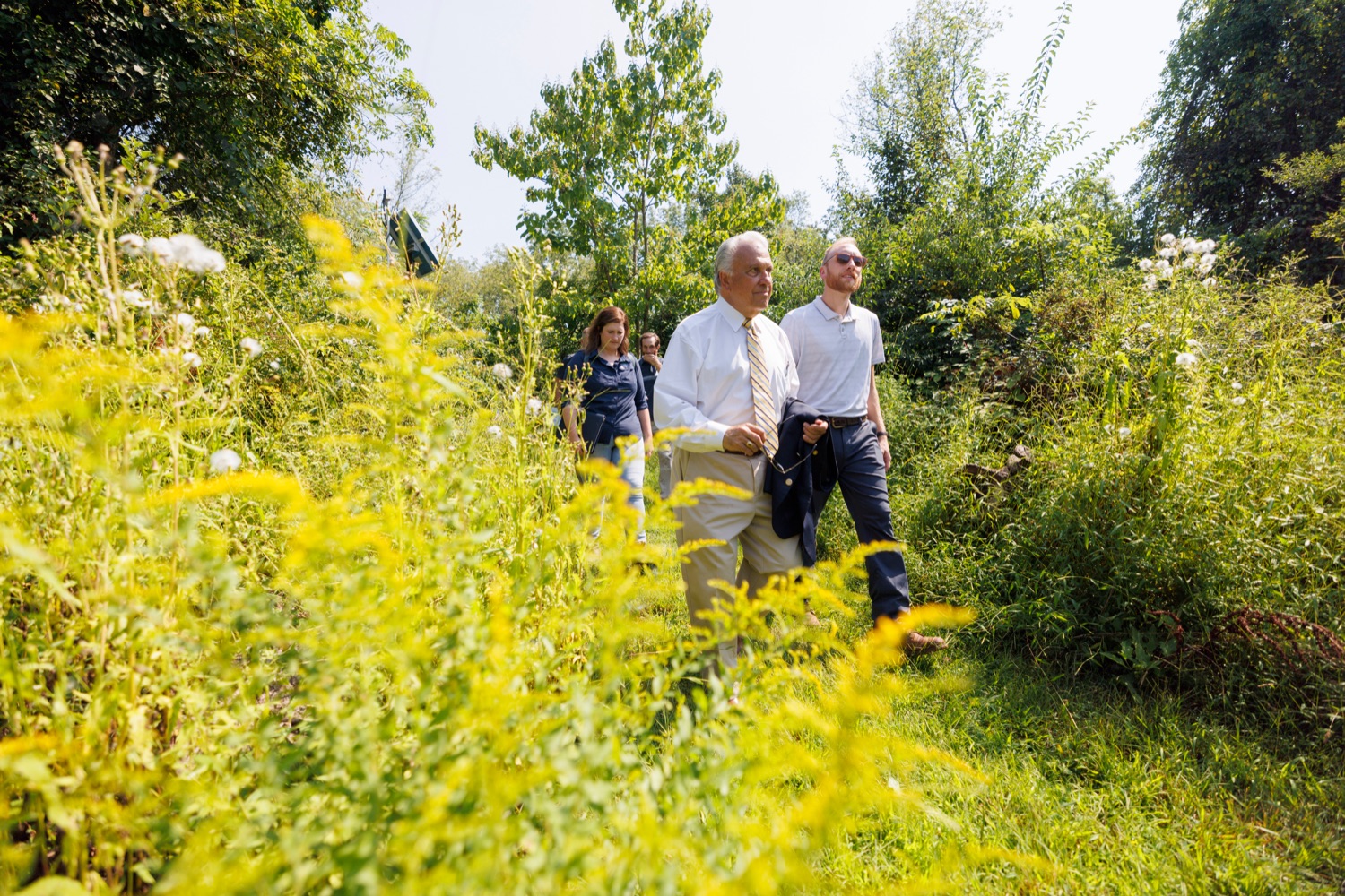 House Agriculture and Rural Affairs Committee co-chair Eddie Day Pashinski, left, and Hardwoods Development Councils Jon Geyer pass by native Goldenrod at Ambler Field Station where Temple University is conducting invasive species research and management on Friday, September 8, 2023.<br><a href="https://filesource.amperwave.net/commonwealthofpa/photo/23666_AGRIC_Invasive_Species_NK_003.JPG" target="_blank">⇣ Download Photo</a>